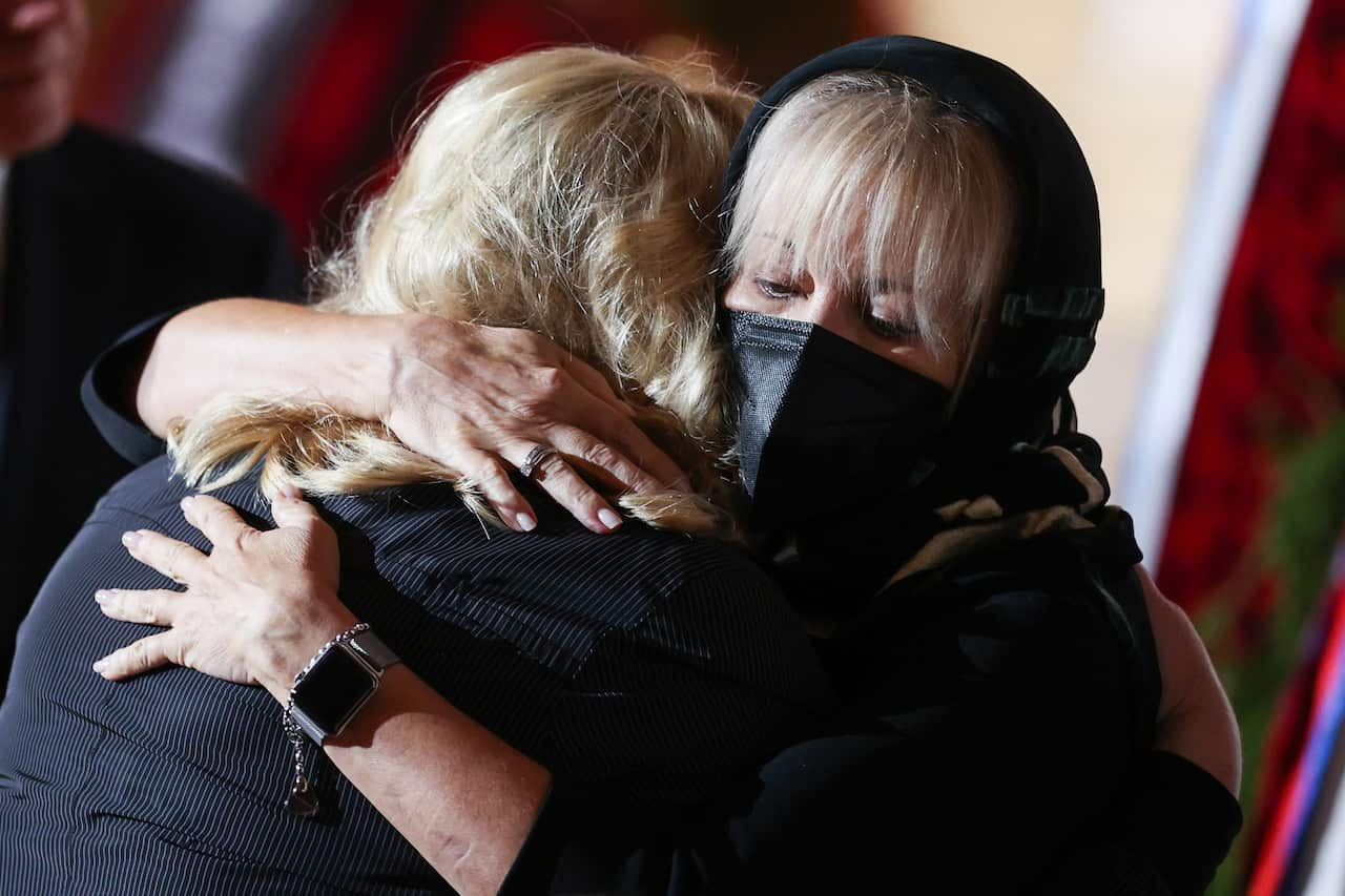 Mikhail Gorbachev's daughter, Irina Gorbacheva-Virganskaya (right), hugs a person at the funeral for her father. 