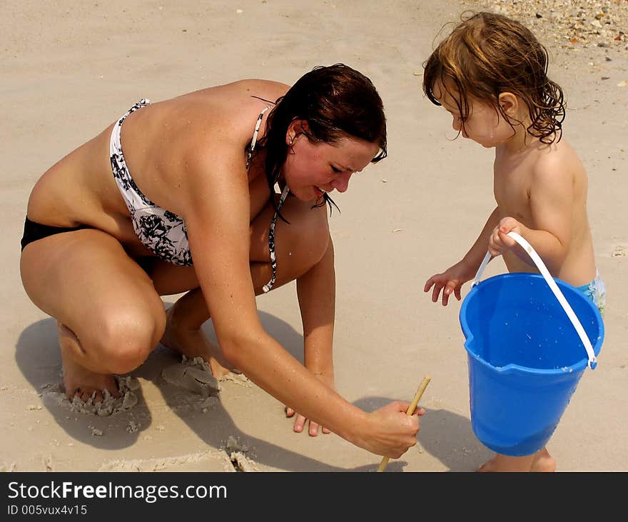 Mother and child playing together at beach