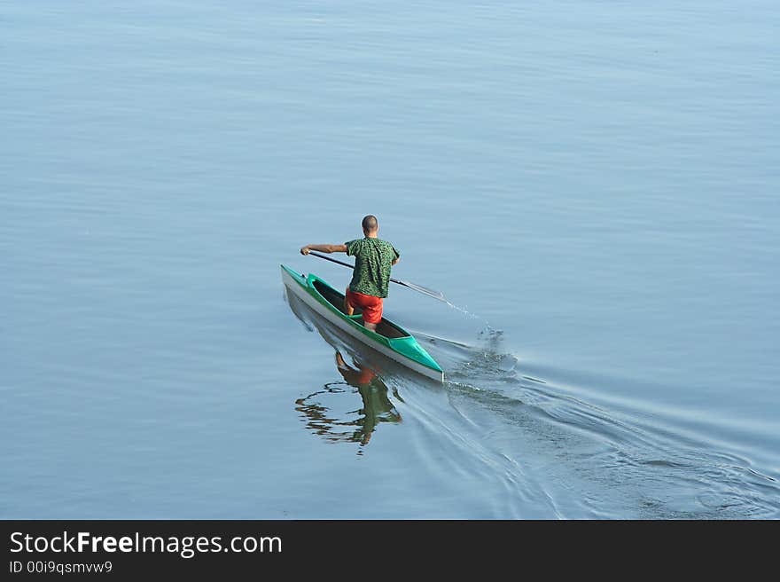 Sportsman rowing in the lake. Sportsman rowing in the lake.