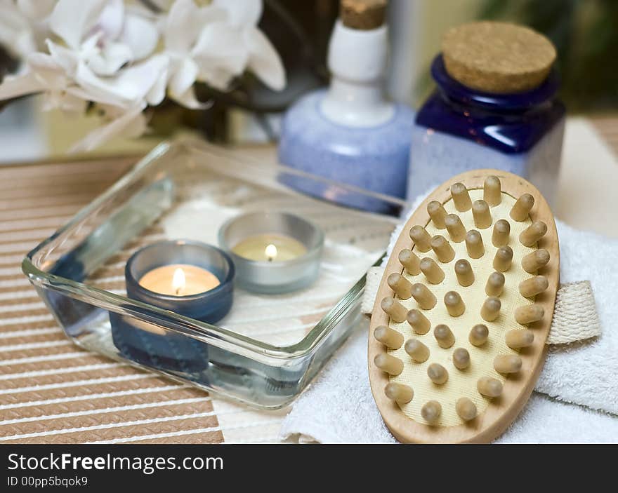 A spa composition consisting of 2 small candles submerged in a glass bowl and a massage brush. MORE SPA COMPOSITIONS ». A spa composition consisting of 2 small candles submerged in a glass bowl and a massage brush. MORE SPA COMPOSITIONS »