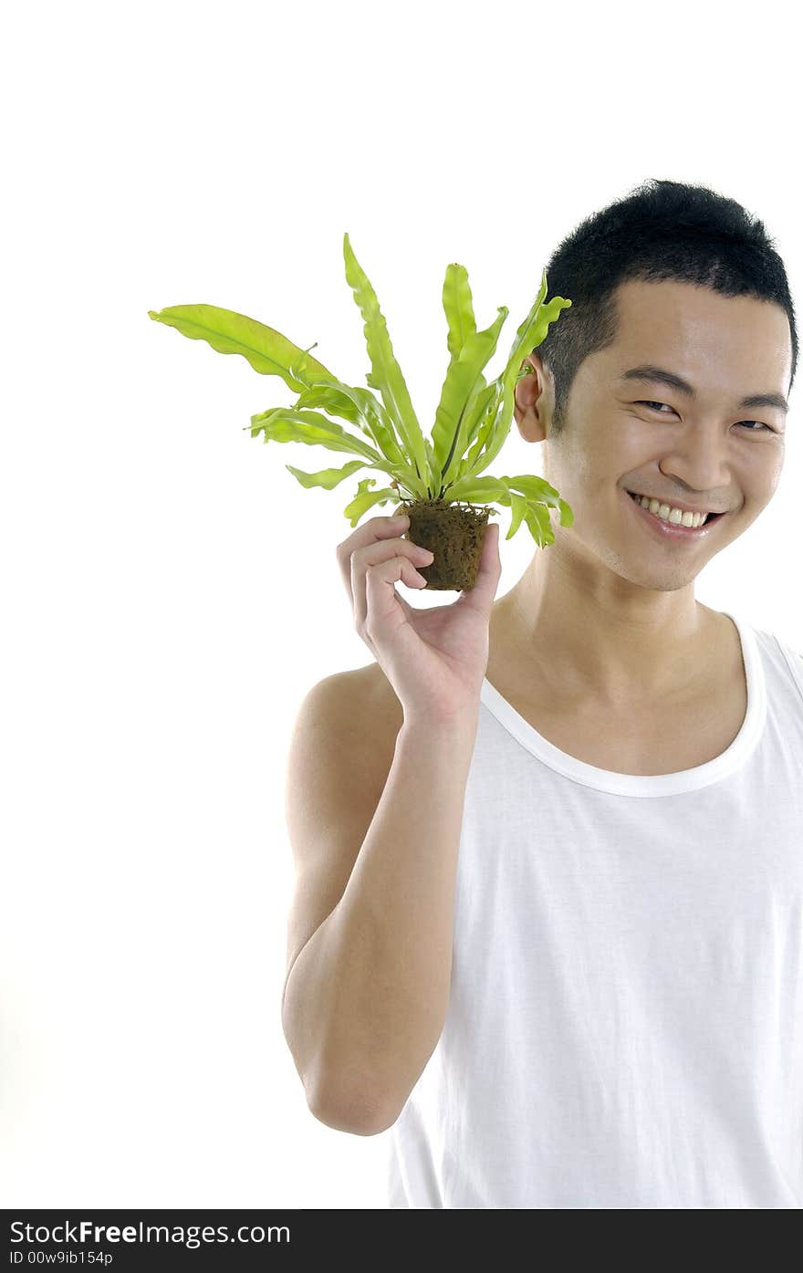 Young man on holding a small plant