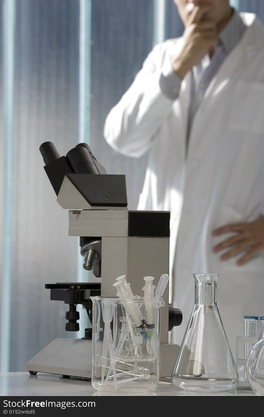 Scientist thinking in his lab, focus on the microscope. Scientist thinking in his lab, focus on the microscope