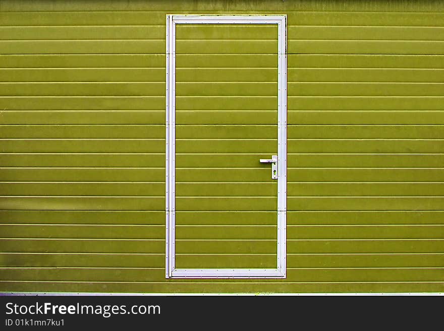 Simple metal door in yellow wall. Simple metal door in yellow wall