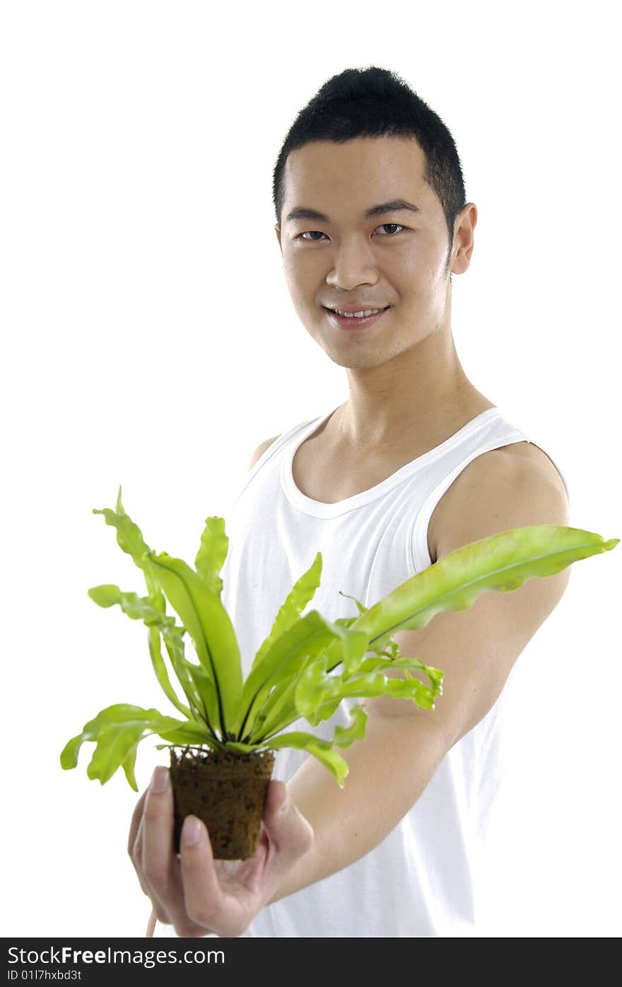 Young man holding up a green leaf. Young man holding up a green leaf