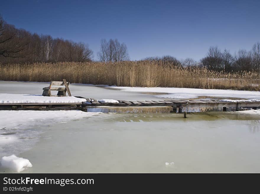 Pier with a pew wintertime on the lake, high density range image. Pier with a pew wintertime on the lake, high density range image