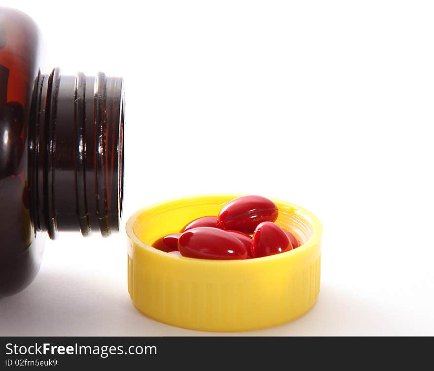 Packaging red capsules on white background. health image