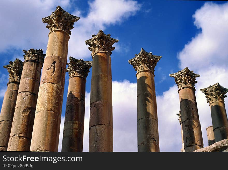 Old corinthian pillars from roman empire in Jerash, Jordan against blue sky. Old corinthian pillars from roman empire in Jerash, Jordan against blue sky