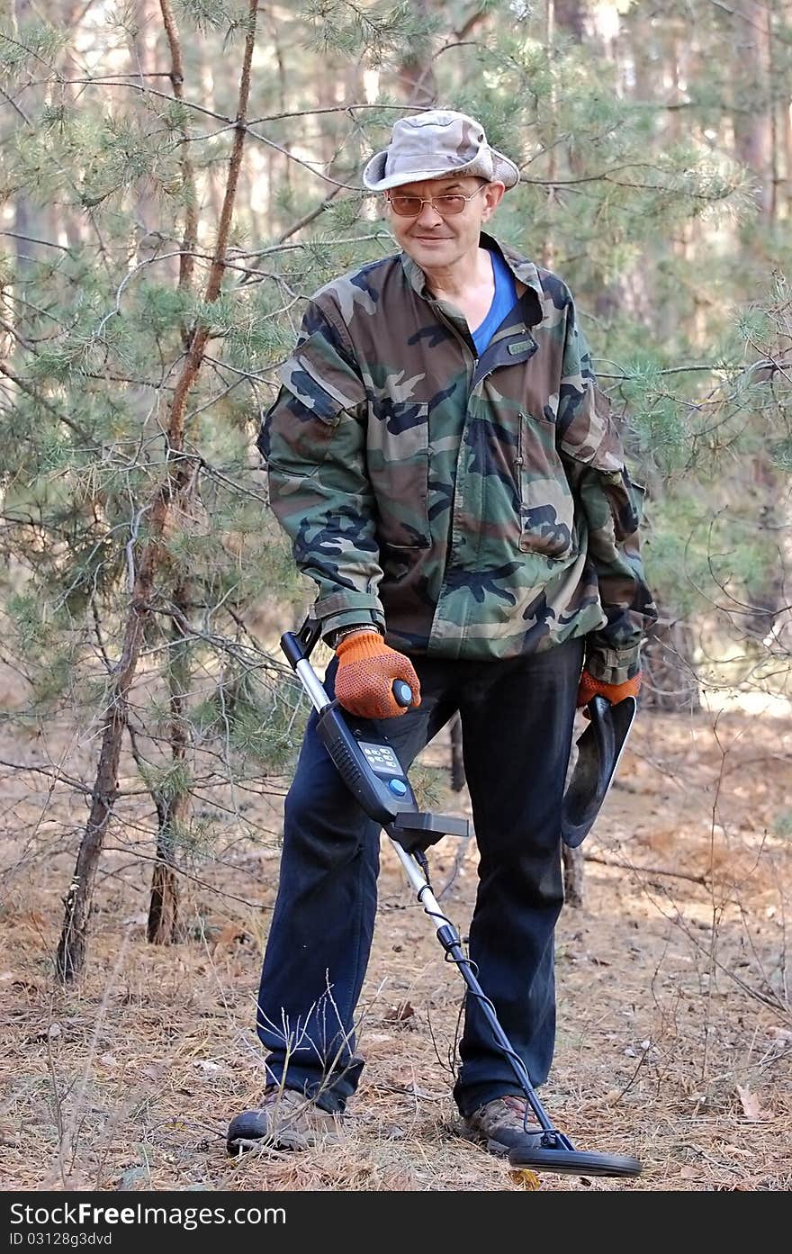 Military archeology. Man with metal detector on the battlefield of WW2.Ukraine