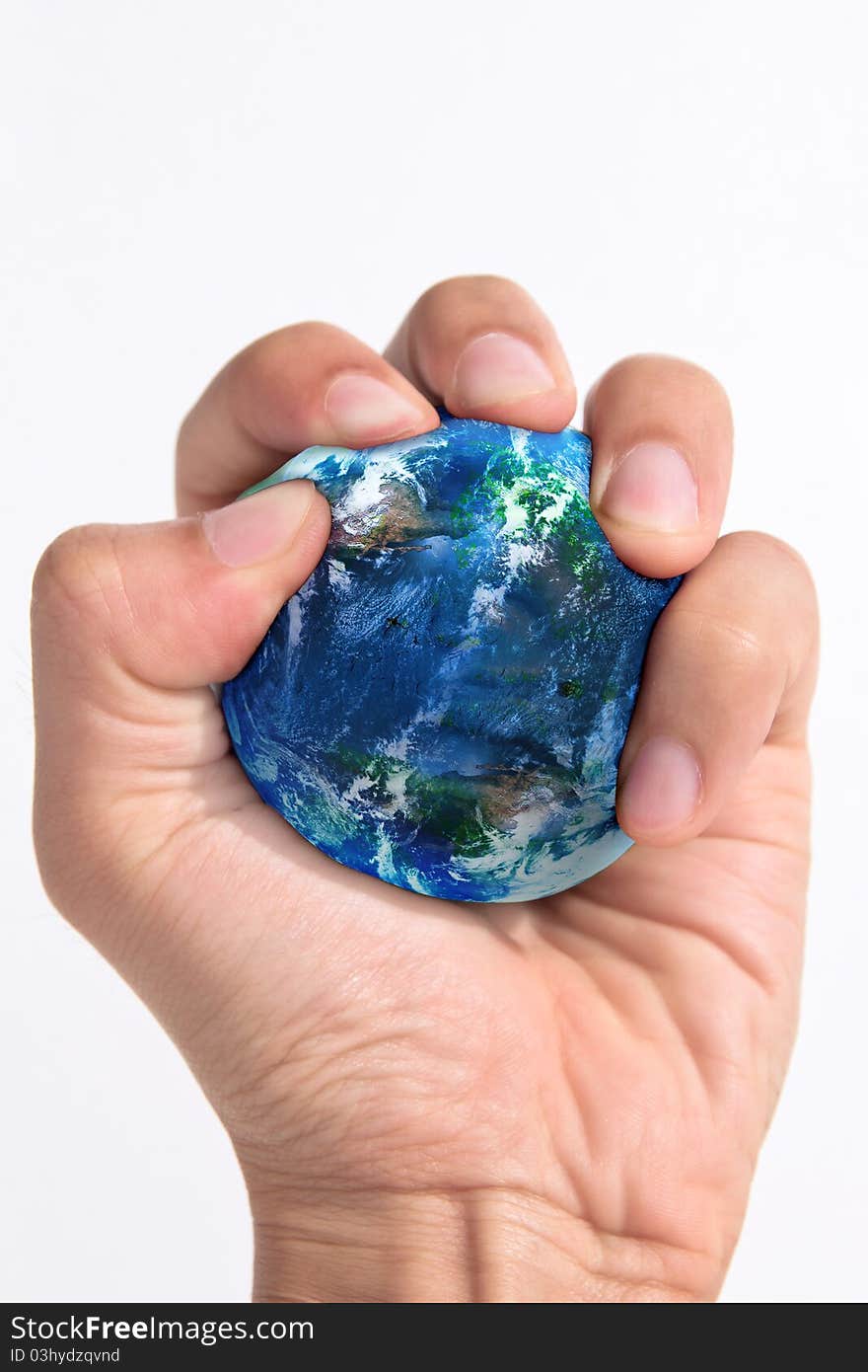 Hand squeezing earth on white background