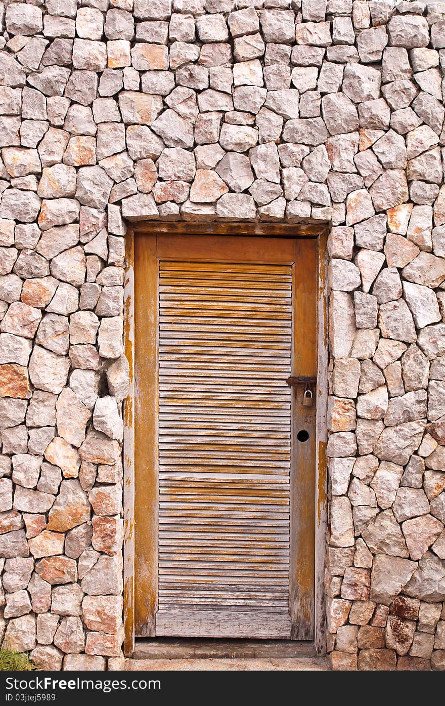 Surface texture of stone wall decoration and wooden door. Surface texture of stone wall decoration and wooden door