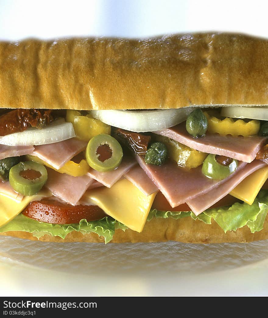 Sandwich hero, on white plate with toppings. Sandwich hero, on white plate with toppings