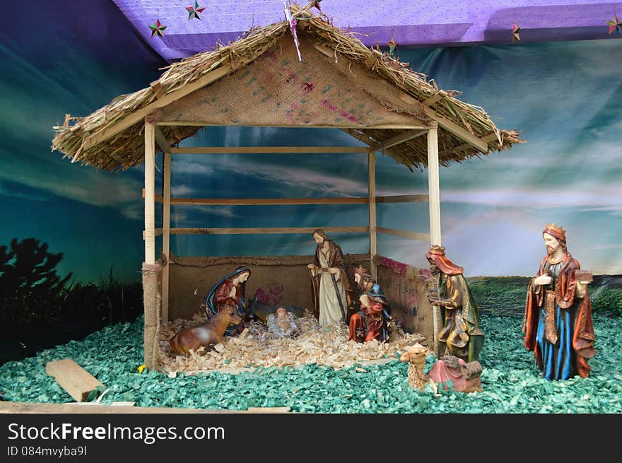 There is small hut having beautiful decoration of birth of Jesus Christ. I have clicked this picture during Christmas festival, 2013 at Ahmedabad. Decoration having camels, goats, starts, mother merry, moon, grass, angels and well wishers. There is small hut having beautiful decoration of birth of Jesus Christ. I have clicked this picture during Christmas festival, 2013 at Ahmedabad. Decoration having camels, goats, starts, mother merry, moon, grass, angels and well wishers.