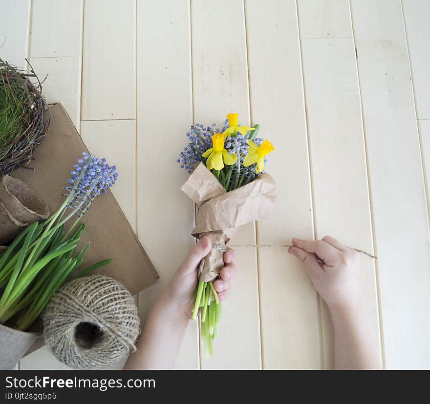 Children`s hands collect a bouquet as a gift. A gift for mom.