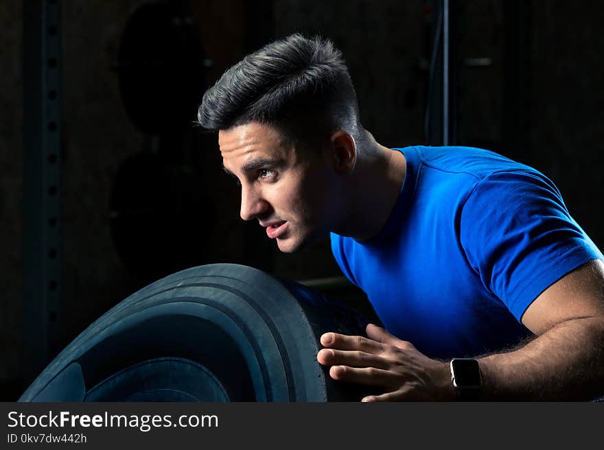 Close-up portrait of an athlete exercising with a wheel