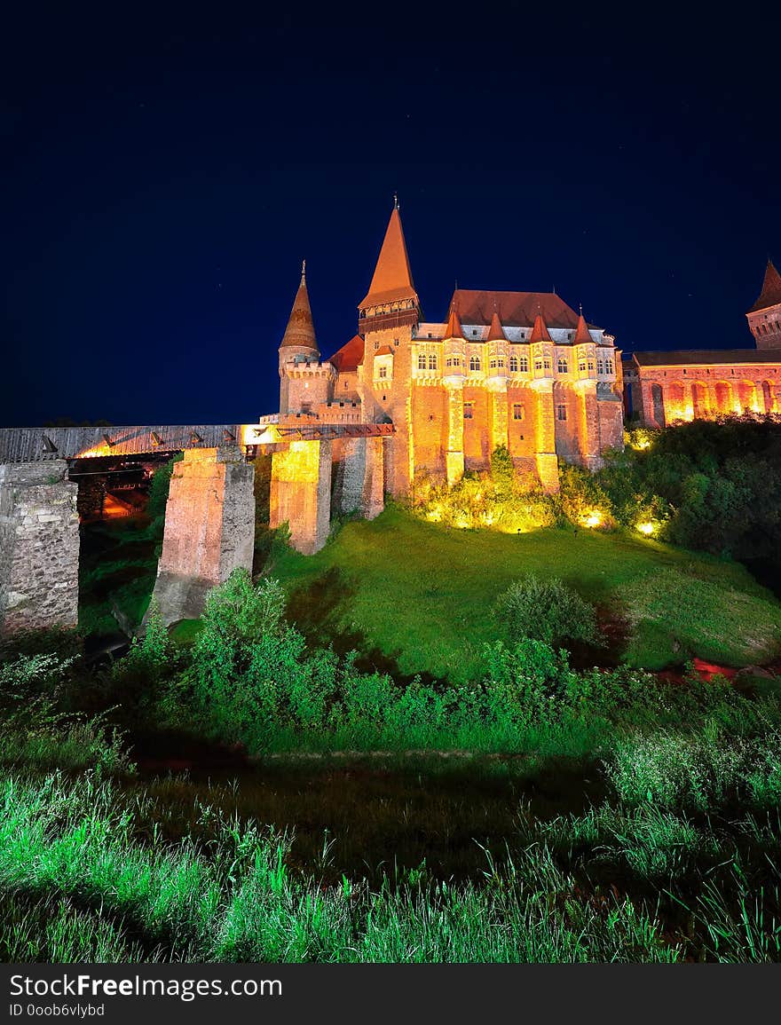 Beautiful night panorama of the Hunyad Castle / Corvin`s Castle with wooden bridge