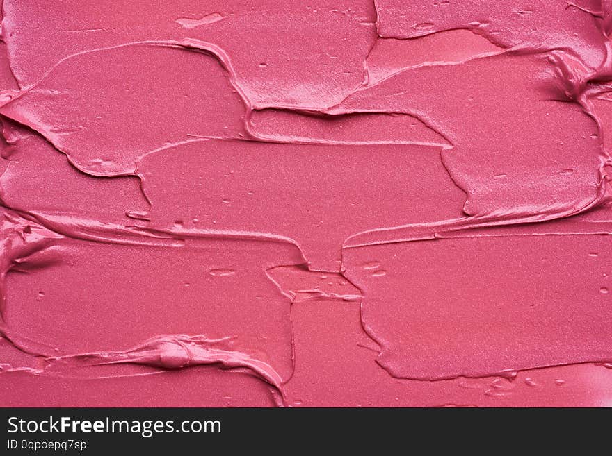 Gently pink strokes and texture of lip gloss or acrylic paint isolated on white background