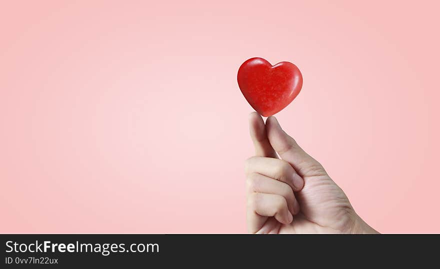 Hands holding a red heart. heart health. and donation concepts