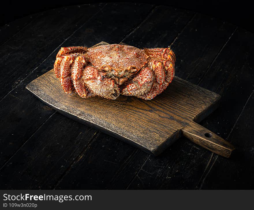 Chinese mitten crab on a cutting board. Shanghai hairy crab. Wooden background. Chinese mitten crab on a cutting board. Shanghai hairy crab. Wooden background