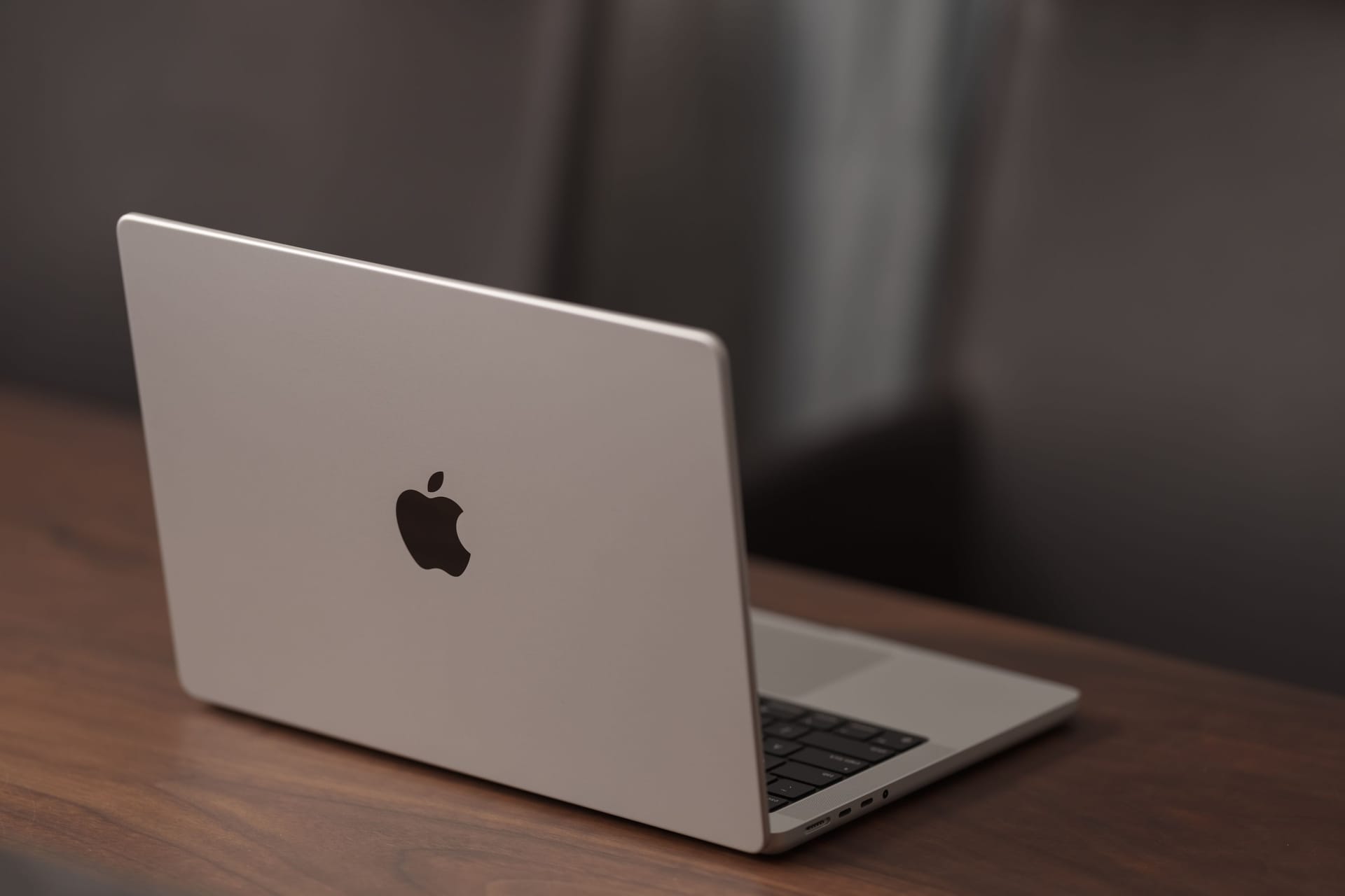 Saint-Petersburg, Russia - Circa December, 2022: open apple macbook pro 14 inch on walnut table