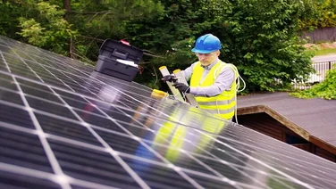 Someone installing solar panels