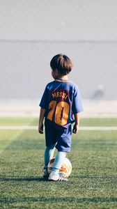 Preview wallpaper child, football player, football, football field, ball, lawn