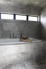 "The shower room in the main bathroom is covered completely in gray limestone to allow for a sauna/steam room and also provides a neutral palette for optimum relaxation,” says the firm. “The material disappears when the steam shower gets going!”