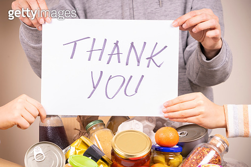 Thank you for donation. Volunteers holding paper sheet with message ...