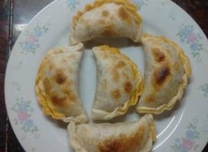 Una foto de Empanadas al horno de carne de cerdo cortada a cuchillo