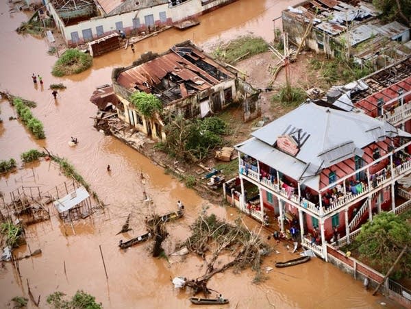 People walk on the flooded streets of Buzi, Mozambique