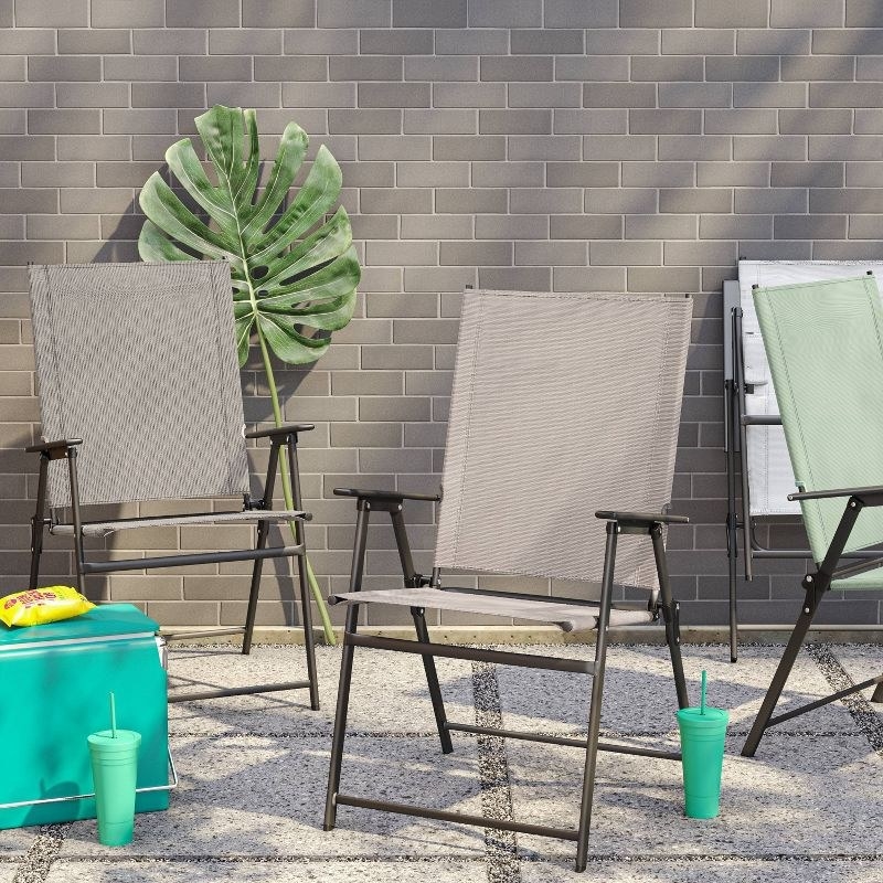 the chair in grey and the chair in tan on a patio