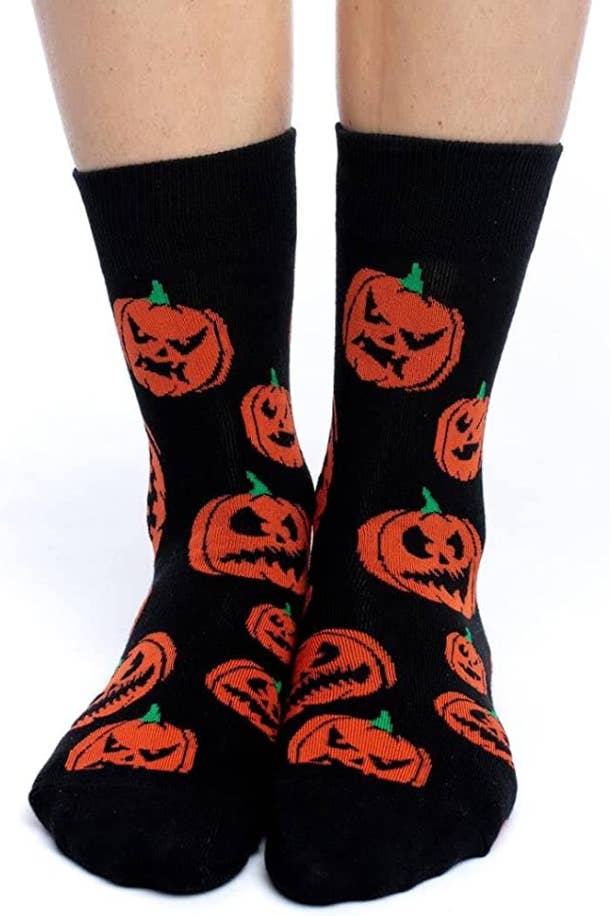 black socks with an angry pumpkin pattern