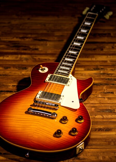 Free Photo | Electric guitar body close-up view is on the wood floor