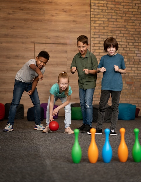 Free Photo | Full shot kids playing bowling