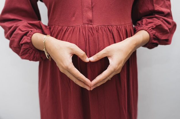 Premium Photo | Asian Muslim pregnant woman holding her belly stomach ...