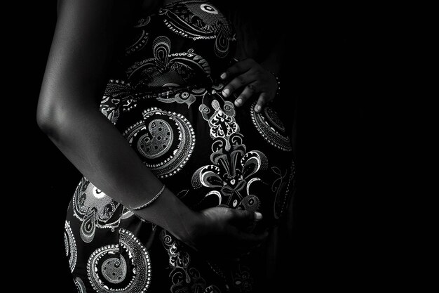 Premium Photo | Black and white image of pregnant woman holding her belly