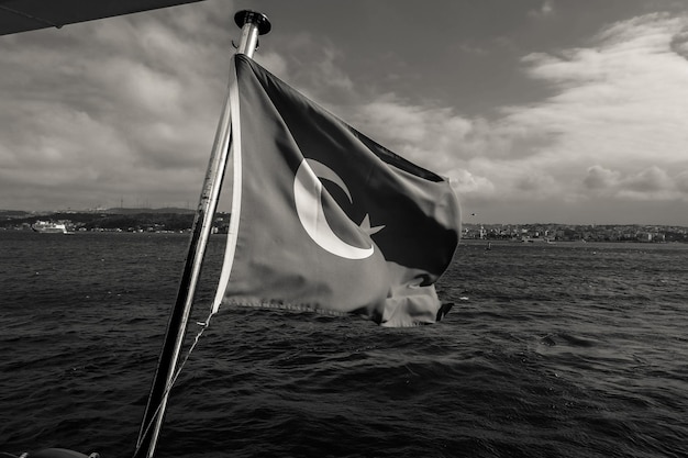 Black and white turkish flag floating on the marmara sea