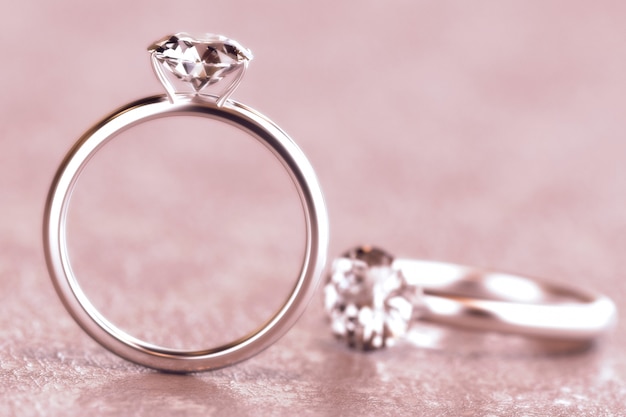 Couple of round diamond cut ring isolated on pink background,\
3d rendering.