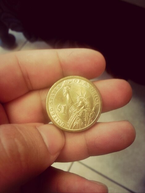 Premium Photo | Cropped hand holding gold coin