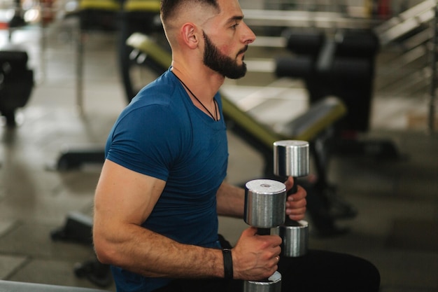 Premium Photo | Male bodybuilder trains in the gym bearded man