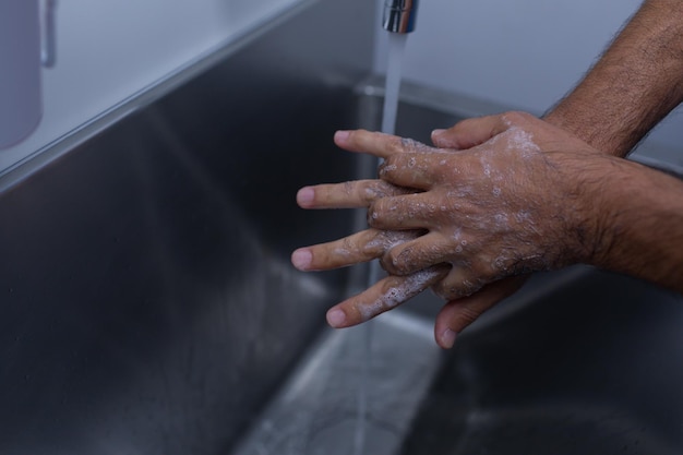 Premium Photo | Male surgeon washing hands in sink at hospital