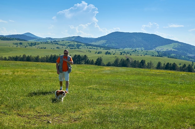 Premium Photo | Man and his dog in a wonderful mountain landscape in spring