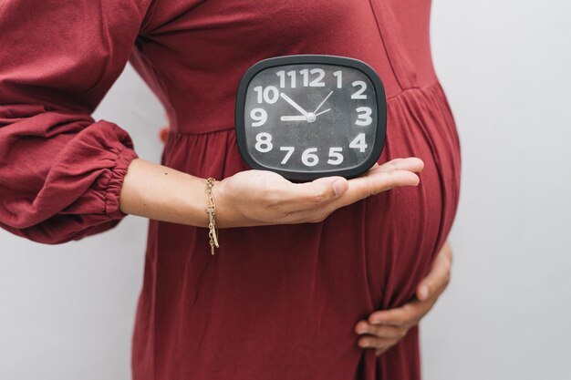 Premium Photo | Muslim pregnant woman holding her belly stomach and ...