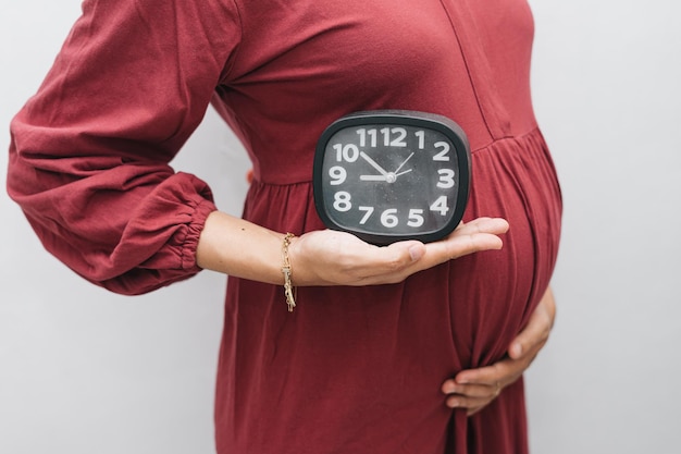 Premium Photo | Muslim pregnant woman holding her belly stomach and ...