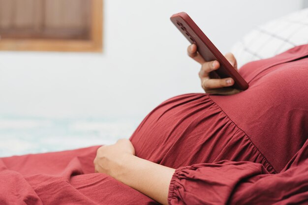 Premium Photo | Muslim pregnant woman holding her belly stomach and ...