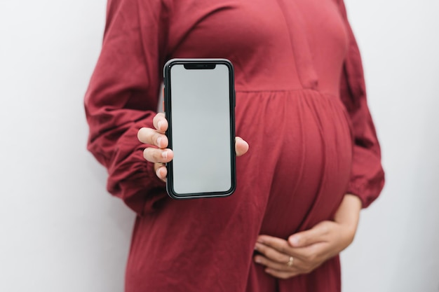 Premium Photo | Muslim pregnant woman holding her belly stomach and ...