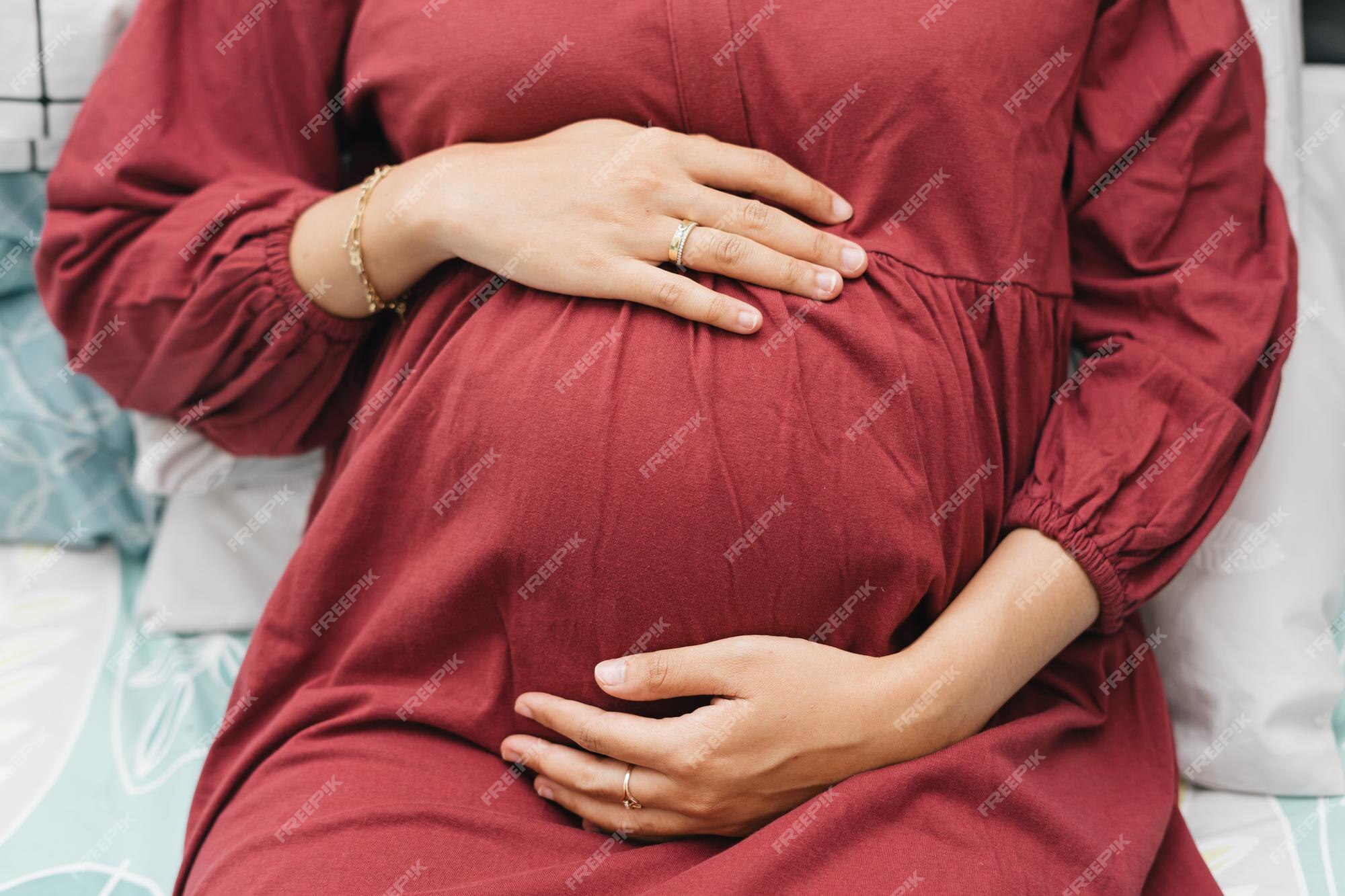 Premium Photo | Muslim pregnant woman holding her belly stomach while ...