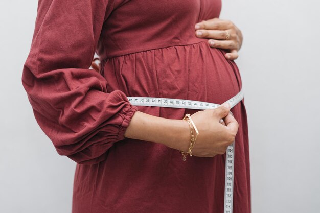 Premium Photo | Muslim pregnant woman measuring her belly stomach