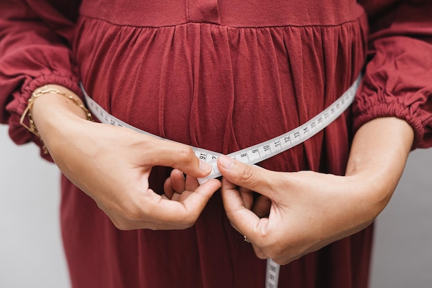 Premium Photo | Muslim pregnant woman measuring her belly stomach