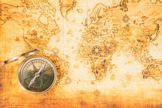 Old paper map with an ancient compass on it. vintage travel\
background