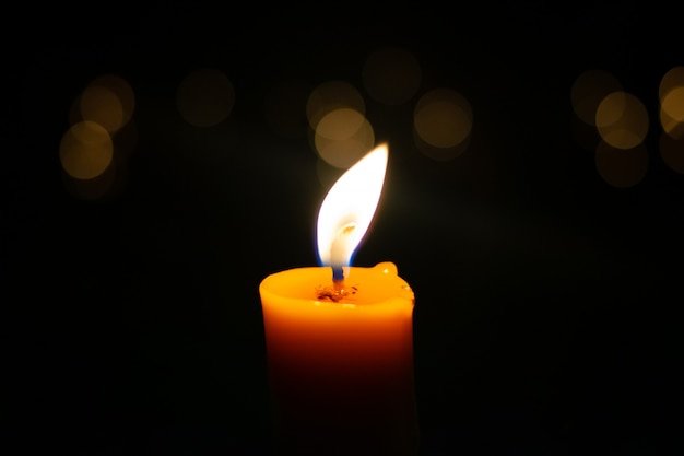 Premium Photo | One light candle burning brightly in the black background